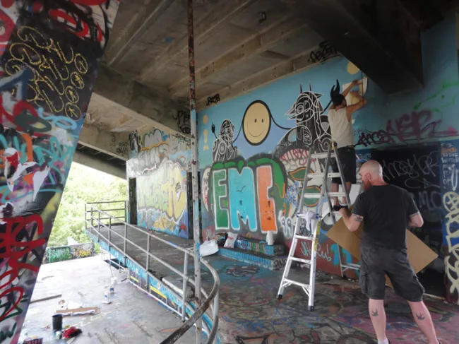 London Police painting alongside an existing Doze Green piece